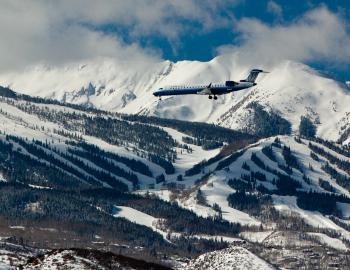 Winter plane flying into aspen